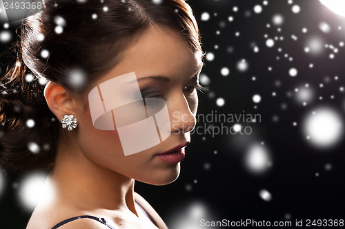 Image of woman in evening dress wearing diamond earrings