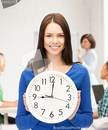 Image of student showing clock