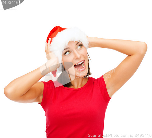 Image of surprised woman in santa helper hat