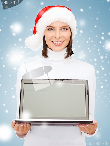 Image of woman in santa helper hat with laptop computer