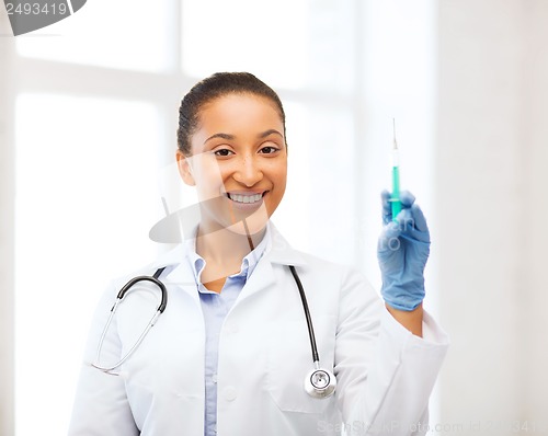 Image of african doctor holding syringe with injection