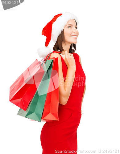 Image of woman in red dress with shopping bags