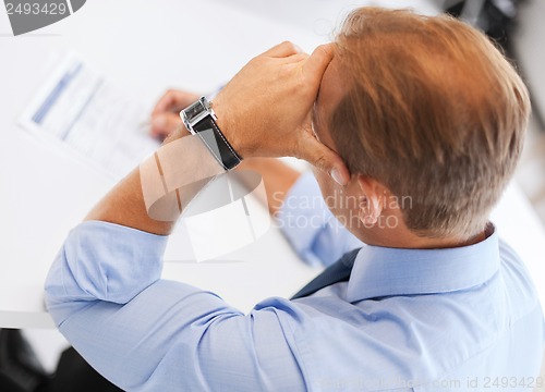 Image of man signing a contract