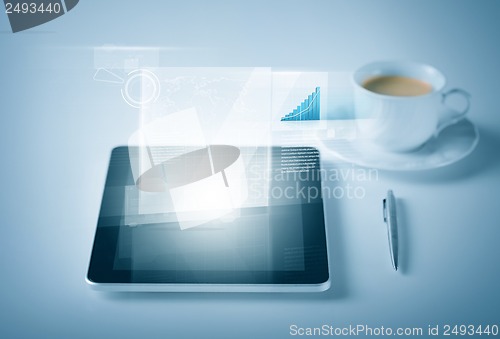 Image of tablet pc with virtual graph or chart