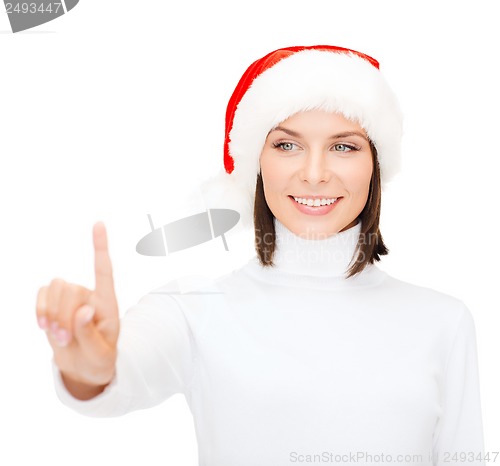 Image of woman in santa helper hat pressing vitrual button