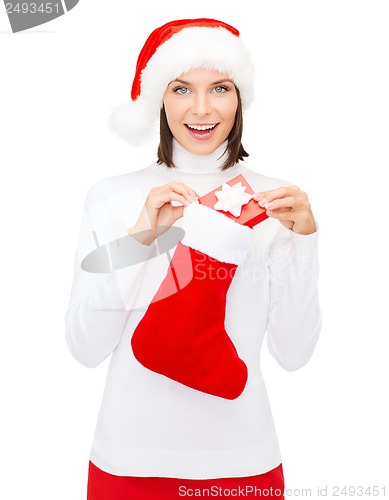 Image of woman in santa hat with gift box and stocking