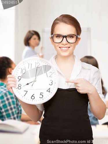 Image of student showing clock