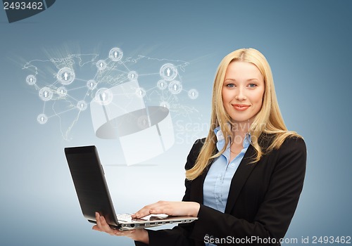 Image of businesswoman with laptop and virtual screen