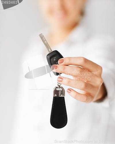 Image of woman hand holding car key