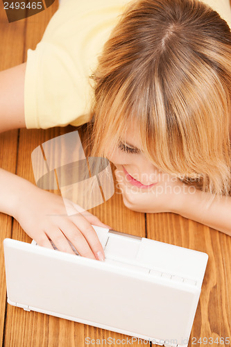 Image of smiling student girl with laptop at school