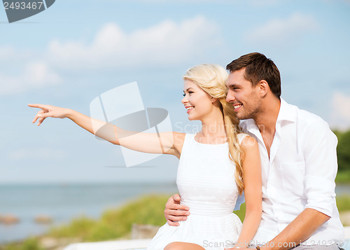 Image of couple sitting at sea side