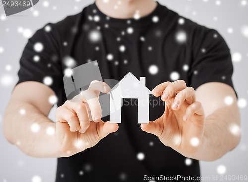 Image of man holding paper house