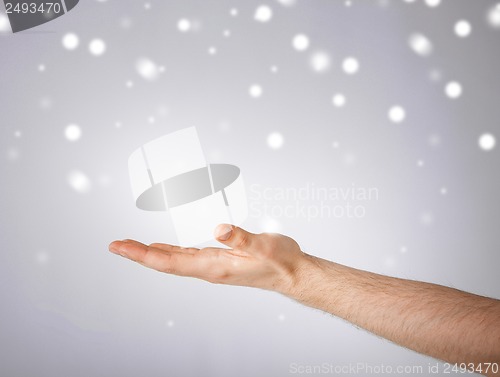 Image of mans hand showing something