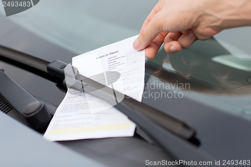 Image of parking ticket on car windscreen