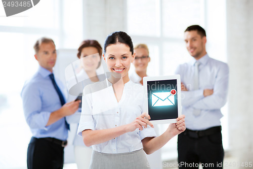 Image of businesswoman holding tablet pc with email sign