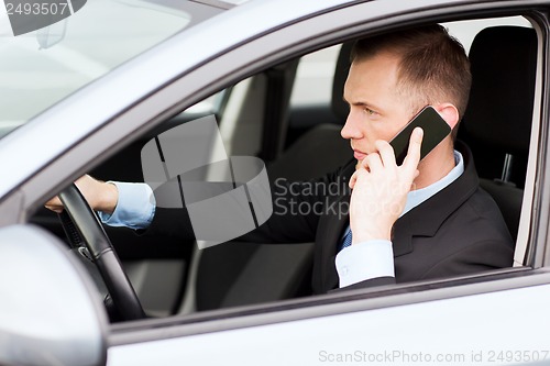 Image of man using phone while driving the car