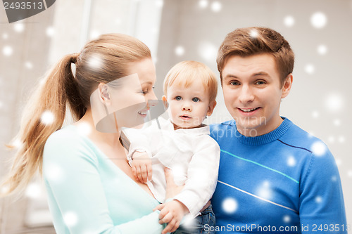 Image of happy parents playing with adorable baby