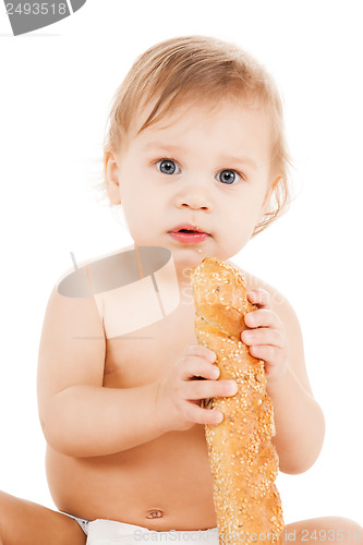 Image of cute todler eating long bread