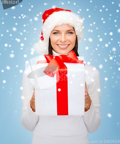 Image of smiling woman in santa helper hat with gift box