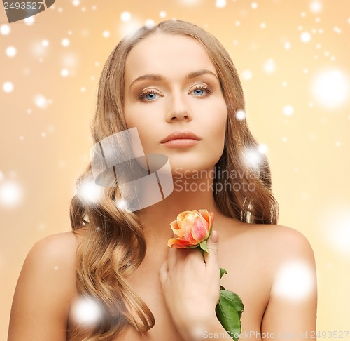 Image of relaxed woman with rose flower