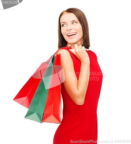 Image of woman in red dress with shopping bags