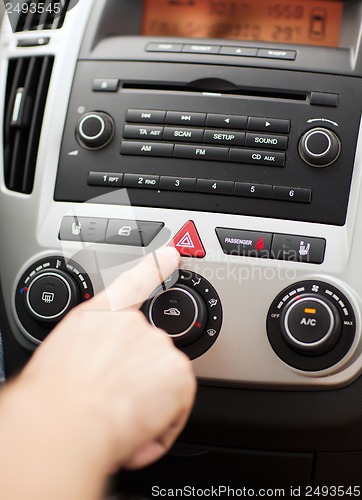 Image of man pressing car hazard warning button