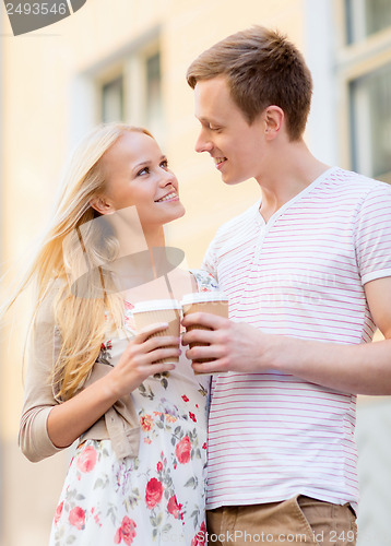 Image of couple in the city with takeaway coffee cups