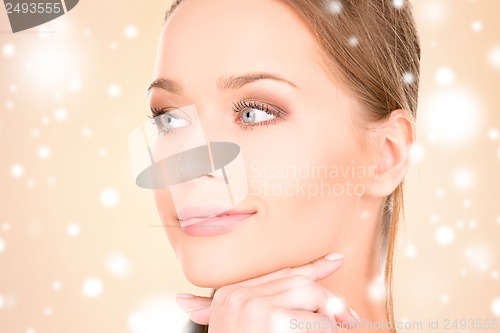Image of face and hand of beautiful woman