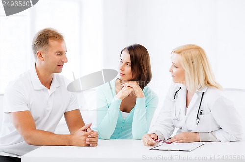 Image of doctor with patients in cabinet