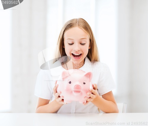 Image of child with piggy bank