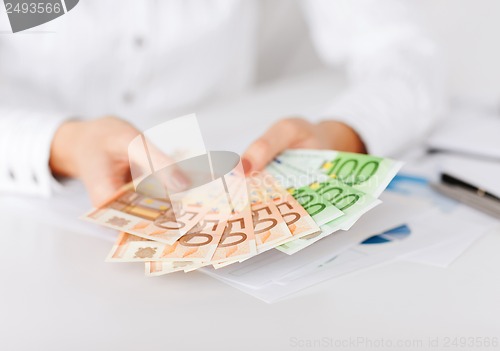 Image of woman hands with euro cash money