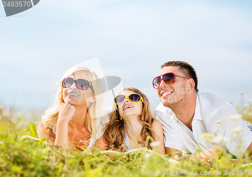 Image of happy family with blue sky and green grass