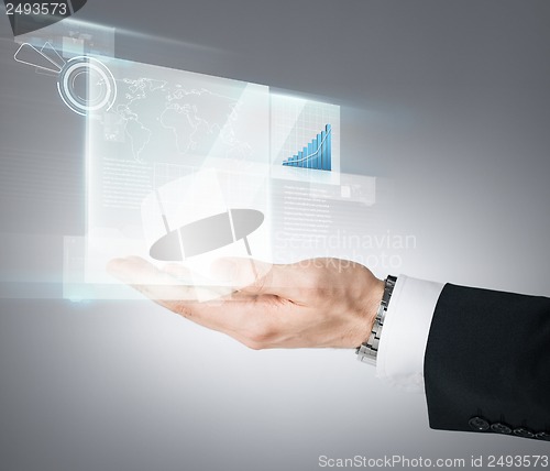 Image of businessman hand showing chart on virtual screen