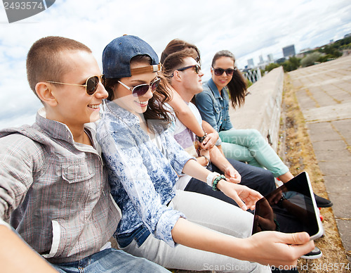 Image of group of teenagers looking at tablet pc