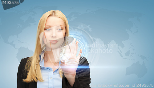 Image of businesswoman touching virtual screen