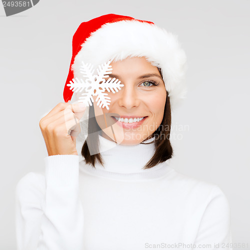 Image of smiling woman in santa helper hat with snowflake