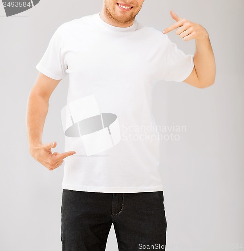 Image of man pointing at blank white t-shir