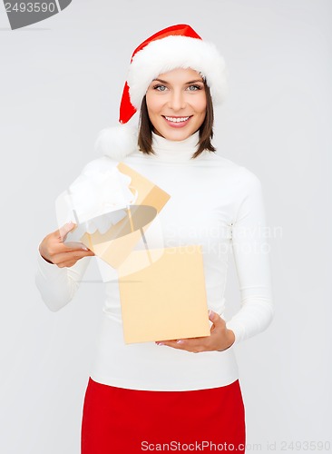 Image of smiling woman in santa helper hat with gift box
