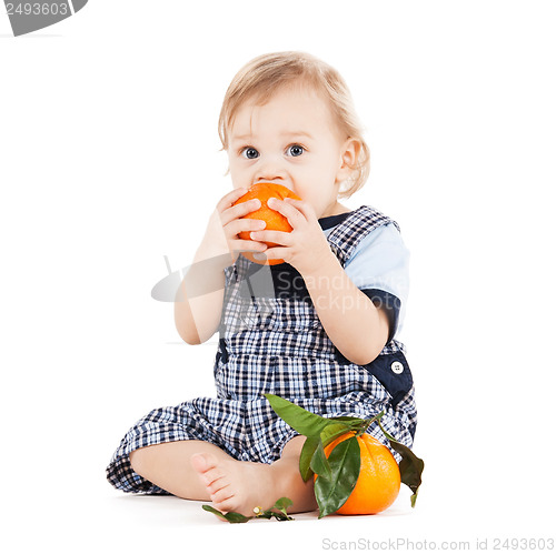 Image of cute toddler eating orange