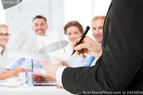 Image of man signing contract