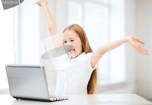 Image of girl with laptop pc at school