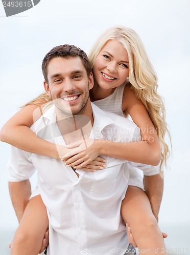 Image of couple having fun on the beach