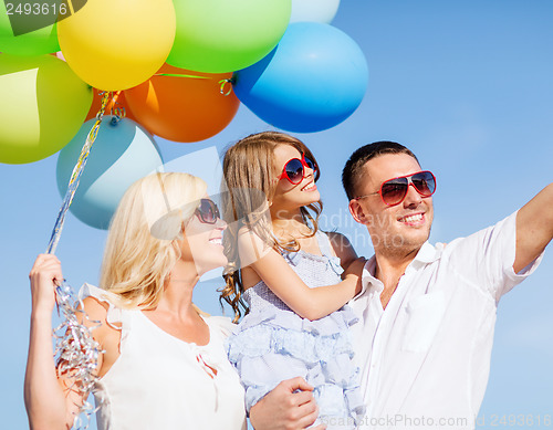 Image of family with colorful balloons