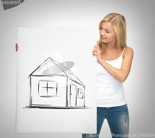 Image of woman holding picture with house