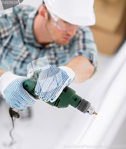 Image of man drilling the wall