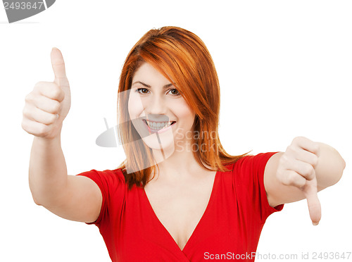 Image of businesswoman with thumbs up and down