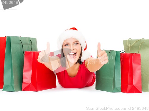 Image of woman in red shirt with shopping bags