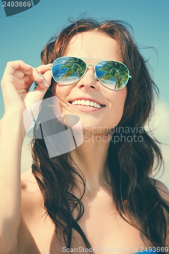 Image of woman in bikini and sunglasses