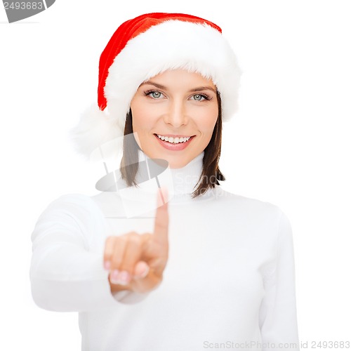 Image of woman in santa helper hat pressing vitrual button