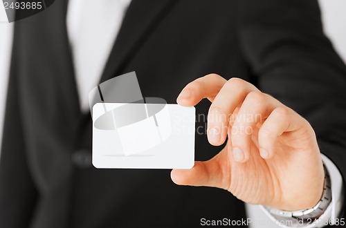 Image of businessman showing blank card